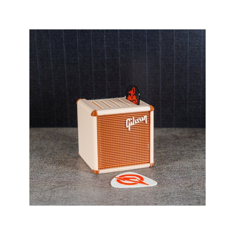 Portapúas con diseño de amplificador vintage en color crema y marrón, con el logotipo Gibson visible, sobre una superficie gris Portapúas con diseño de amplificador vintage en color crema y marrón, con el logotipo Gibson visible, sobre una superficie gris